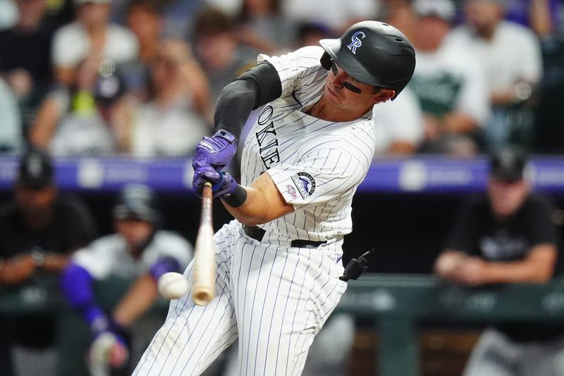 Aug 17, 2024; Denver, Colorado, USA; Colorado Rockies catcher Drew Romo (3) singles in the fifth inning against the San Diego Padres at Coors Field. Mandatory Credit: Ron Chenoy-USA TODAY Sports