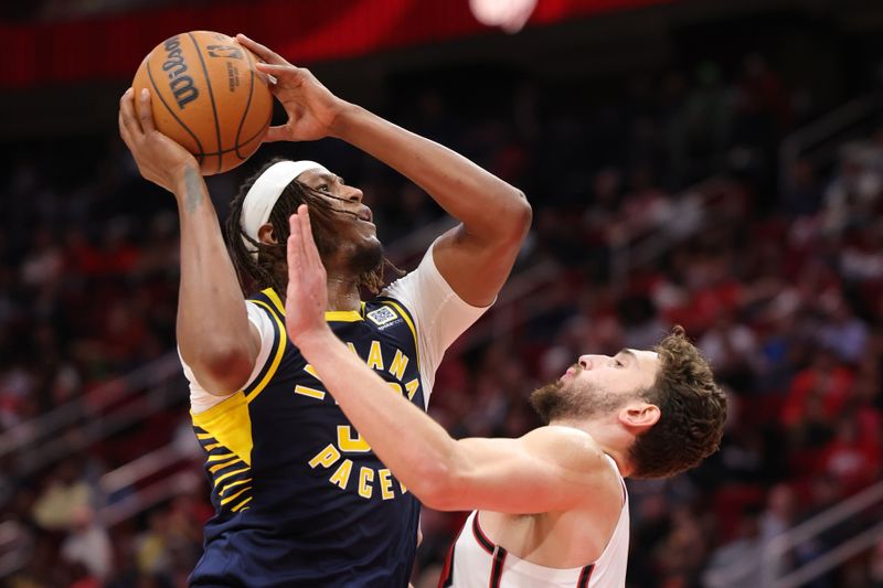 HOUSTON, TEXAS - NOVEMBER 20: Myles Turner #33 of the Indiana Pacers shoots over Alperen Sengun #28 of the Houston Rockets during the first half at Toyota Center on November 20, 2024 in Houston, Texas. NOTE TO USER: User expressly acknowledges and agrees that, by downloading and or using this photograph, User is consenting to the terms and conditions of the Getty Images License Agreement. (Photo by Alex Slitz/Getty Images)