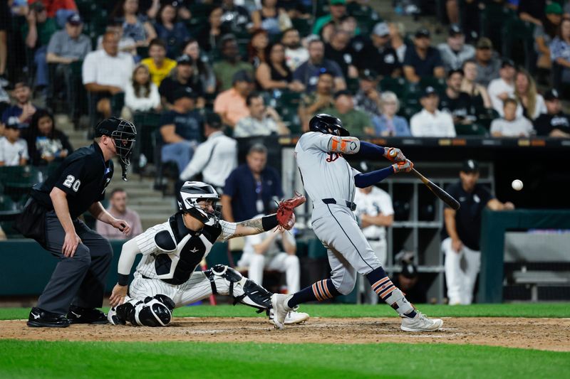 Aug 23, 2024; Chicago, Illinois, USA; Detroit Tigers shortstop Zach McKinstry (39) hits an RBI-single against the Chicago White Sox during the ninth inning at Guaranteed Rate Field. Mandatory Credit: Kamil Krzaczynski-USA TODAY Sports