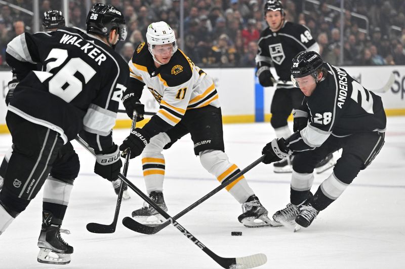 Jan 5, 2023; Los Angeles, California, USA;  Los Angeles Kings center Jaret Anderson-Dolan (28) and Boston Bruins center Trent Frederic (11) go for the puck in the first period at Crypto.com Arena. Mandatory Credit: Jayne Kamin-Oncea-USA TODAY Sports