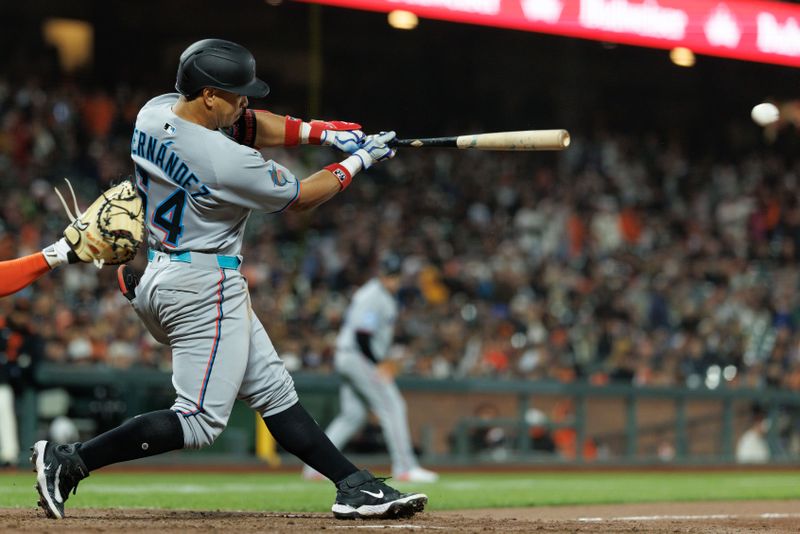 Jun 25, 2025; San Francisco, California, USA; Miami Marlins designated hitter Heriberto Hernandez (64) hits a two run RBI double during the tenth inning against the San Francisco Giants at Oracle Park. Mandatory Credit: Sergio Estrada-Imagn Images