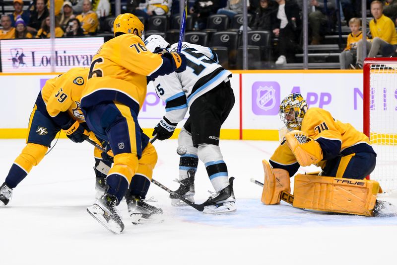 Nov 9, 2024; Nashville, Tennessee, USA;  Nashville Predators goaltender Juuse Saros (74) and defenseman Roman Josi (59) block the deflection of Utah Hockey Club center Alexander Kerfoot (15) during the second period at Bridgestone Arena. Mandatory Credit: Steve Roberts-Imagn Images