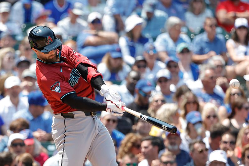 Jul 19, 2024; Chicago, Illinois, USA; Arizona Diamondbacks first baseman Christian Walker (53) hits a two-run single against the Chicago Cubs during the third inning at Wrigley Field. Mandatory Credit: Kamil Krzaczynski-USA TODAY Sports