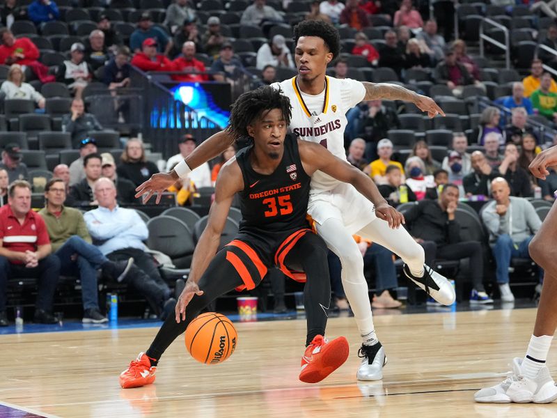 Mar 8, 2023; Las Vegas, NV, USA; Oregon State Beavers forward Glenn Taylor Jr. (35) dribbles against Arizona State Sun Devils guard Desmond Cambridge Jr. (4) during the second half at T-Mobile Arena. Mandatory Credit: Stephen R. Sylvanie-USA TODAY Sports