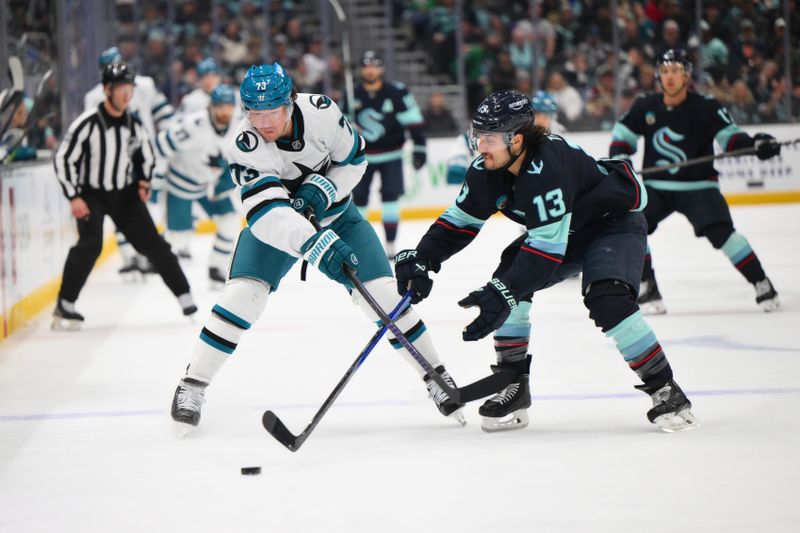 Nov 30, 2024; Seattle, Washington, USA; San Jose Sharks center Tyler Toffoli (73) passes the puck while defended by Seattle Kraken left wing Brandon Tanev (13) during the first period at Climate Pledge Arena. Mandatory Credit: Steven Bisig-Imagn Images