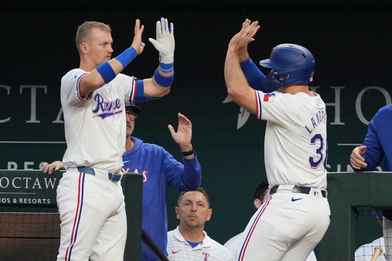 Sep 7, 2024; Arlington, Texas, USA; Texas Rangers center fielder Wyatt Langford (36) celebrates scoring a run with third baseman Josh Jung (6) against the Los Angeles Angels during the fifth inning at Globe Life Field. Mandatory Credit: Jim Cowsert-Imagn Images