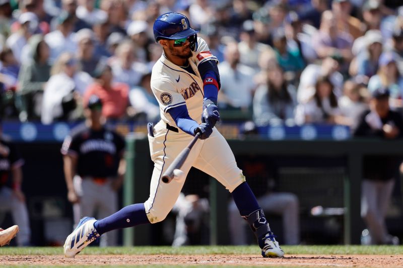 Jun 1, 2025; Seattle, Washington, USA; Seattle Mariners center fielder Julio Rodríguez (44) hits a single against the Minnesota Twins during the ninth inning at T-Mobile Park. Mandatory Credit: John Froschauer-Imagn Images