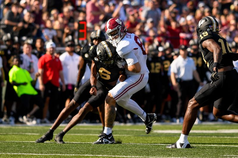 Oct 5, 2024; Nashville, Tennessee, USA;  Vanderbilt Commodores cornerback Kolbey Taylor (6) hits Alabama Crimson Tide tight end Josh Cuevas (80) after a made catch during the first half at FirstBank Stadium. Mandatory Credit: Steve Roberts-Imagn Images