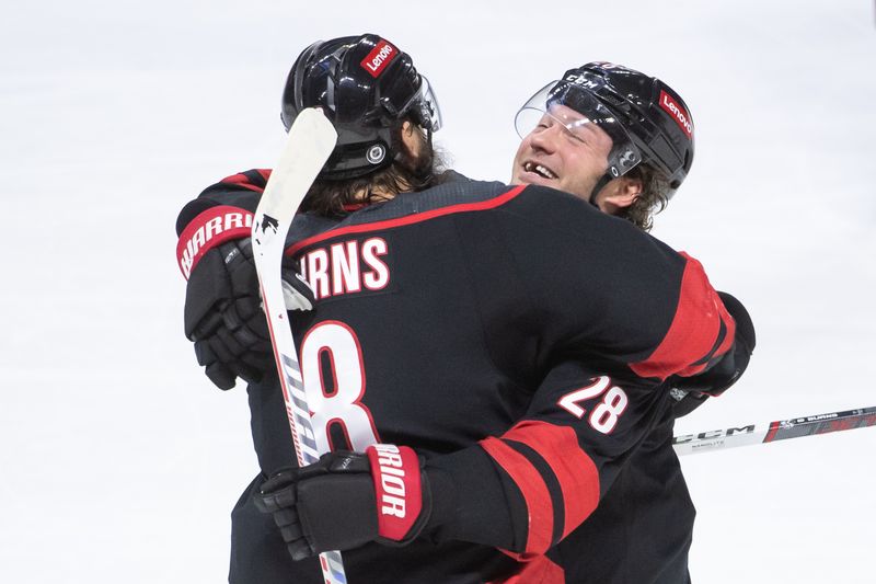 Mar 17, 2024; Ottawa, Ontario, CAN; Carolina Hurricanes defenseman Brent Burns (8) celebrates a tip of his shot by left wing Brendan Lemieux (28) for a goal in the third period against the Ottawa Senators at the Canadian Tire Centre. Mandatory Credit: Marc DesRosiers-USA TODAY Sports