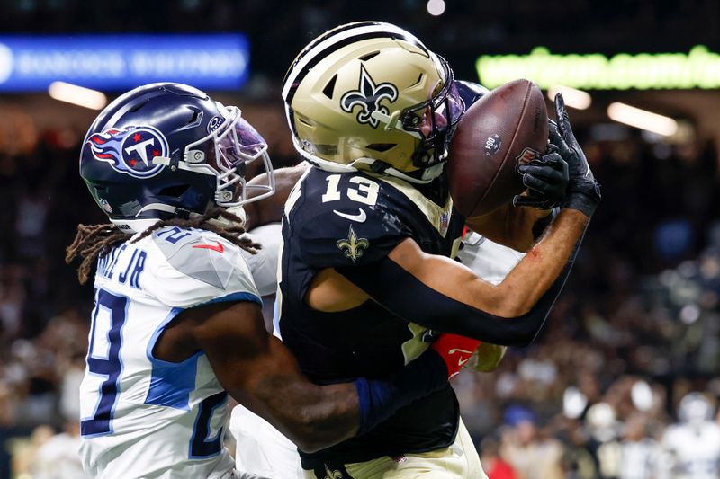 New Orleans Saints wide receiver Equanimeous St. Brown catches a touchdown pass ahead of Tennessee Titans cornerback Jarvis Brownlee Jr. during the first half of an NFL preseason football game , Sunday, Aug. 25, 2024, in New Orleans. (AP Photo/Butch Dill)