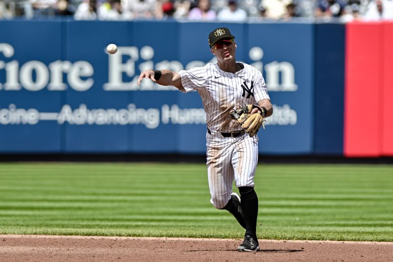 May 19, 2024; Bronx, New York, USA; New York Yankees shortstop Anthony Volpe (11) fields a ground ball and throws to first base for an out during the third inning against the Chicago White Sox at Yankee Stadium. Mandatory Credit: John Jones-USA TODAY Sports