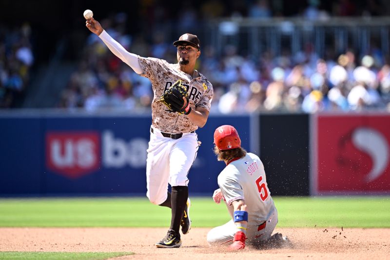 Apr 28, 2024; San Diego, California, USA; San Diego Padres second baseman Xander Bogaerts (2) throws to first base after forcing out Philadelphia Phillies second baseman Bryson Stott (5) at second base to complete a double play during the sixth inning at Petco Park. Mandatory Credit: Orlando Ramirez-USA TODAY Sports