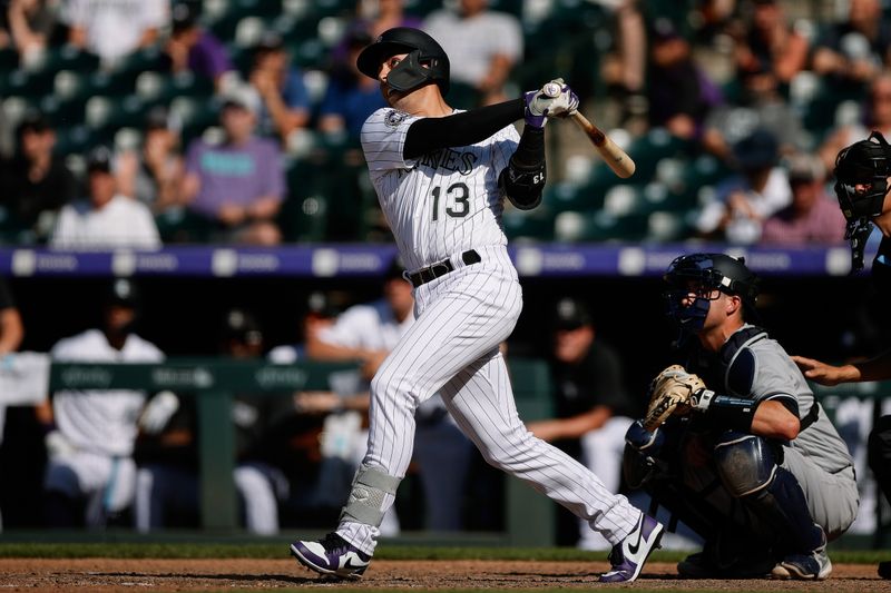 Jul 16, 2023; Denver, Colorado, USA; Colorado Rockies second baseman Alan Trejo (13) watches his ball on a walk-off solo home run in the eleventh inning against the New York Yankees at Coors Field. Mandatory Credit: Isaiah J. Downing-USA TODAY Sports