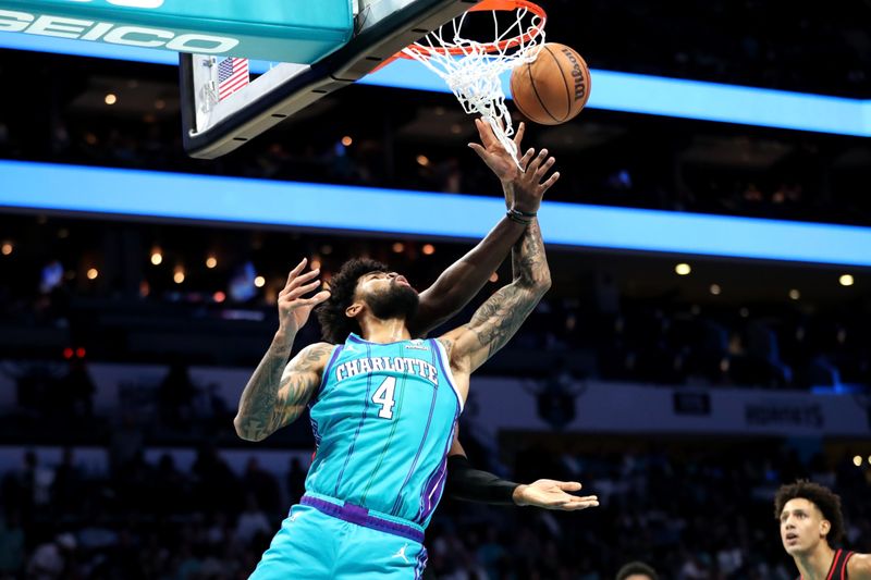 CHARLOTTE, NORTH CAROLINA - OCTOBER 25: Nick Richards #4 of the Charlotte Hornets lays the ball up during the second half of a basketball game against the Atlanta Hawks at Spectrum Center on October 25, 2023 in Charlotte, North Carolina. NOTE TO USER: User expressly acknowledges and agrees that, by downloading and or using this photograph, User is consenting to the terms and conditions of the Getty Images License Agreement. (Photo by David Jensen/Getty Images)