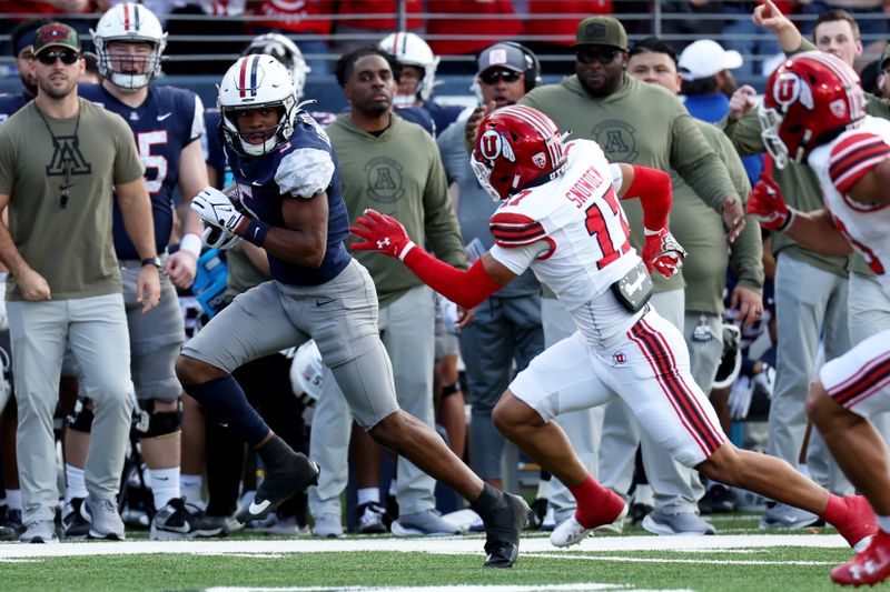 Nov 18, 2023; Tucson, Arizona, USA; Arizona Wildcats wide receiver Montana Lemonious-Craig (5) runs the ball against Utah Utes cornerback Smith Snowden (17) during the first half at Arizona Stadium. Mandatory Credit: Zachary BonDurant-USA TODAY Sports