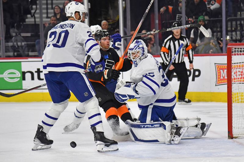 Mar 19, 2024; Philadelphia, Pennsylvania, USA; Philadelphia Flyers defenseman Cam York (8) battles with Toronto Maple Leafs defenseman Joel Edmundson (20) and goaltender Ilya Samsonov (35) during the first period at Wells Fargo Center. Mandatory Credit: Eric Hartline-USA TODAY Sports