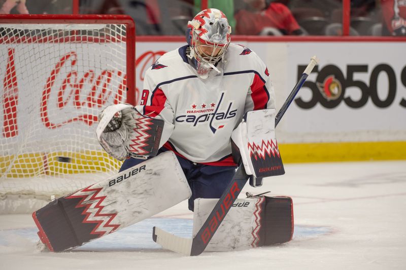 Oct 20, 2022; Ottawa, Ontario, CAN; Washington Capitals goalie Charlie Lindgren (79) makes a save during warmup prior to game against the  Ottawa Senators at the Canadian Tire Centre. Mandatory Credit: Marc DesRosiers-USA TODAY Sports