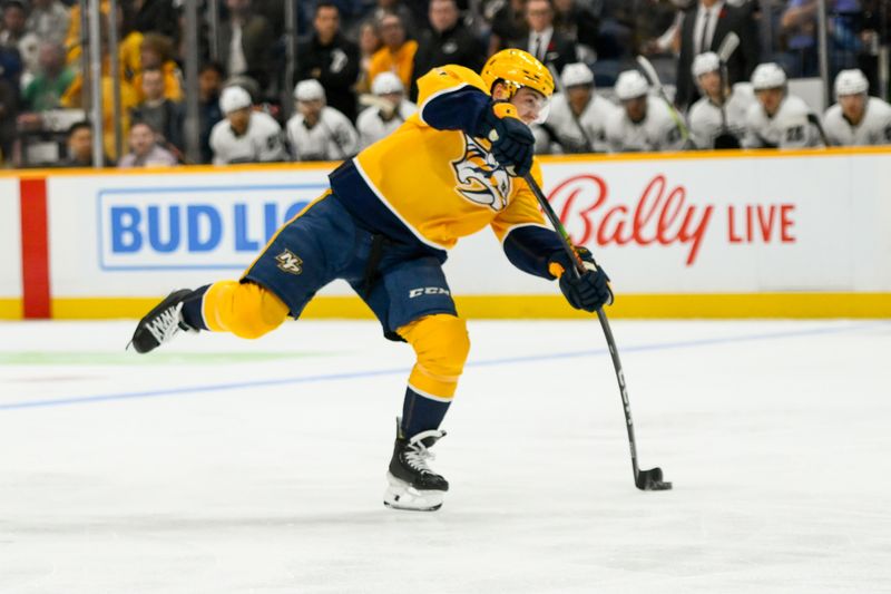 Nov 4, 2024; Nashville, Tennessee, USA;  Nashville Predators center Tommy Novak (82) takes a shot on goal against the Los Angeles Kings during the first period at Bridgestone Arena. Mandatory Credit: Steve Roberts-Imagn Images