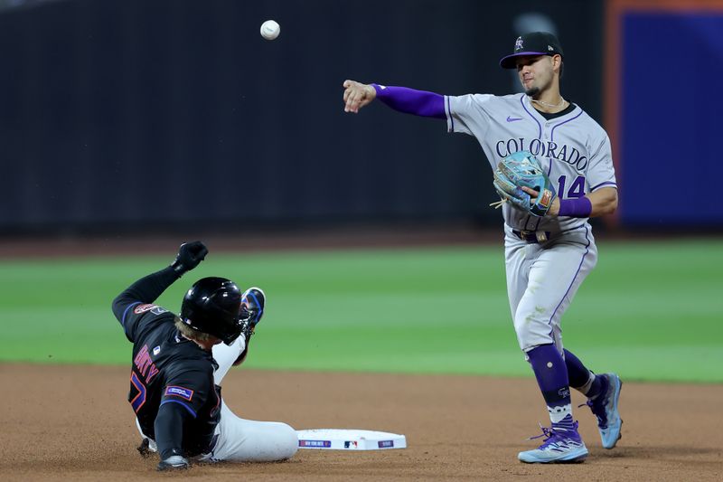 May 30, 2025; New York City, New York, USA; Colorado Rockies shortstop Ezequiel Tovar (14) forces out New York Mets third baseman Brett Baty (7) at second base and throws to first to complete a double play on a ball hit by Mets right fielder Juan Soto (not pictured) during the eighth inning at Citi Field. Mandatory Credit: Brad Penner-Imagn Images