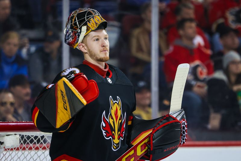 Mar 14, 2024; Calgary, Alberta, CAN; Calgary Flames goaltender Dustin Wolf (32) reacts during the first period against the Vegas Golden Knights at Scotiabank Saddledome. Mandatory Credit: Sergei Belski-USA TODAY Sports