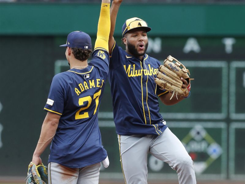 Sep 26, 2024; Pittsburgh, Pennsylvania, USA;  Milwaukee Brewers shortstop Willy Adames (27) and left fielder Jackson Chourio (11) celebrate  after defeating the Pittsburgh Pirates at PNC Park. The Brewers won 5-2. Mandatory Credit: Charles LeClaire-Imagn Images