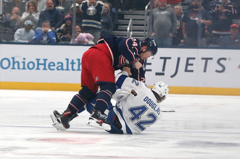 Oct 18, 2025; Columbus, Ohio, USA; Tampa Bay Lightning center Curtis Douglas (42) and Columbus Blue Jackets center Mathieu Olivier (24) fight during the first period at Nationwide Arena. Mandatory Credit: Russell LaBounty-Imagn Images