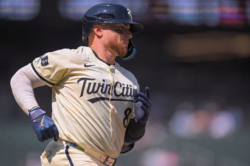 Jul 13, 2025; Minneapolis, Minnesota, USA; Minnesota Twins catcher Christian Vazquez (8) heads to first on a single against the Pittsburgh Pirates during the eighth inning at Target Field. Mandatory Credit: Nick Wosika-Imagn Images