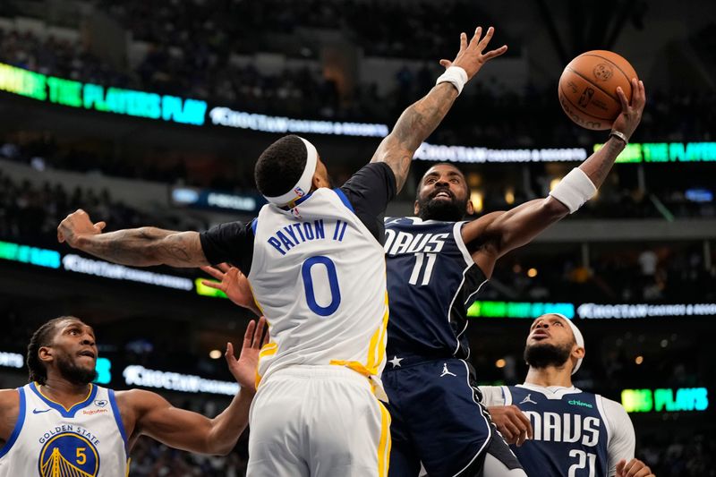 DALLAS, TEXAS - APRIL 05: Kyrie Irving #11 of the Dallas Mavericks is defended by Gary Payton II #0 of the Golden State Warriors during the first half at American Airlines Center on April 05, 2024 in Dallas, Texas. NOTE TO USER: User expressly acknowledges and agrees that, by downloading and or using this photograph, User is consenting to the terms and conditions of the Getty Images License Agreement. (Photo by Sam Hodde/Getty Images)