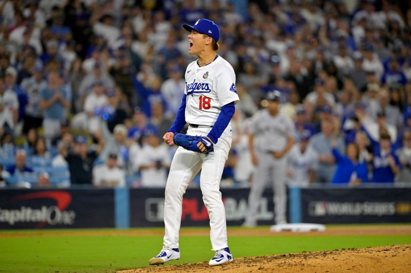 Oct 26, 2024; Los Angeles, California, USA; Los Angeles Dodgers pitcher Yoshinobu Yamamoto (18) reacts in the sixth inning against the New York Yankees during game two of the 2024 MLB World Series at Dodger Stadium. Mandatory Credit: Jayne Kamin-Oncea-Imagn Images