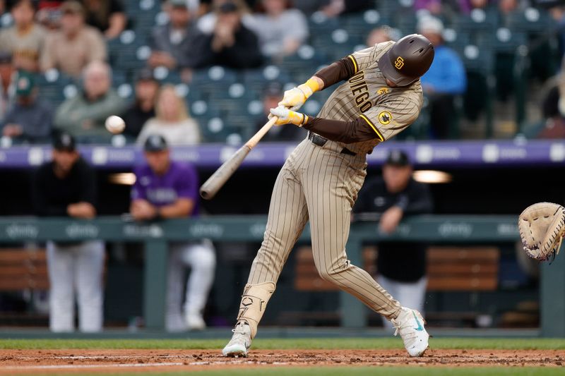 Apr 22, 2024; Denver, Colorado, USA; San Diego Padres center fielder Jackson Merrill (3) hits a single in the fourth inning against the Colorado Rockies at Coors Field. Mandatory Credit: Isaiah J. Downing-USA TODAY Sports