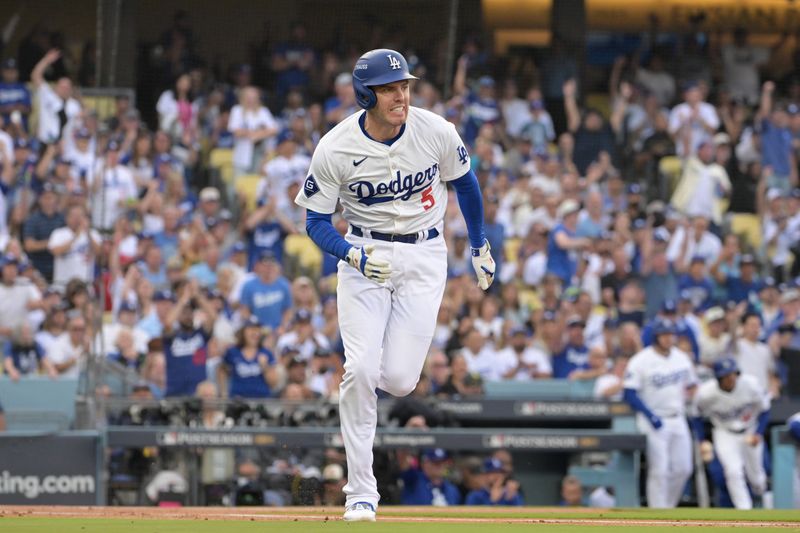 Oct 11, 2024; Los Angeles, California, USA; Los Angeles Dodgers first baseman Freddie Freeman (5) runs after hitting a single in the first inning during game five of the NLDS for the 2024 MLB Playoffs at Dodger Stadium. Mandatory Credit: Jayne Kamin-Oncea-Imagn Images