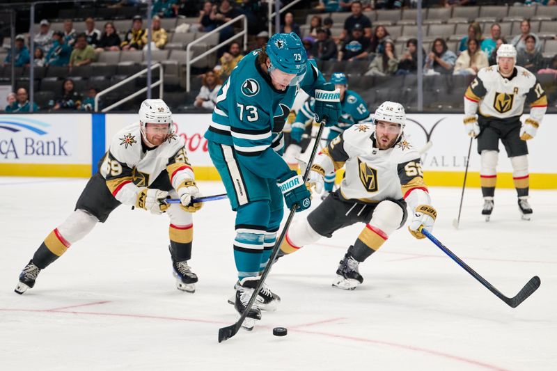 Sep 21, 2025; San Jose, California, USA; San Jose Sharks center Tyler Toffoli (73) shoots the puck against Vegas Golden Knights left wing Jackson Hallum (59) and defenseman Dylan Coghlan (52) during the second period at SAP Center at San Jose. Mandatory Credit: Robert Edwards-Imagn Images