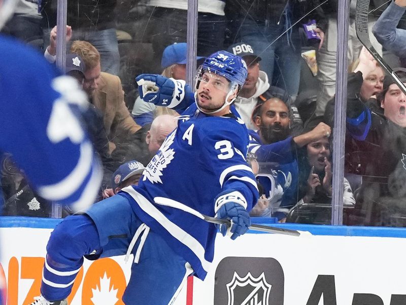 Mar 26, 2024; Toronto, Ontario, CAN; Toronto Maple Leafs center Auston Matthews (34) celebrates scoring a goal against the New Jersey Devils during the second period at Scotiabank Arena. Mandatory Credit: Nick Turchiaro-USA TODAY Sports