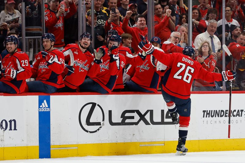 Apr 15, 2024; Washington, District of Columbia, USA; Washington Capitals center Nic Dowd (26) celebrates with teammates after scoring an empty net goal against the Boston Bruins in the final minute of the third period at Capital One Arena. Mandatory Credit: Geoff Burke-USA TODAY Sports