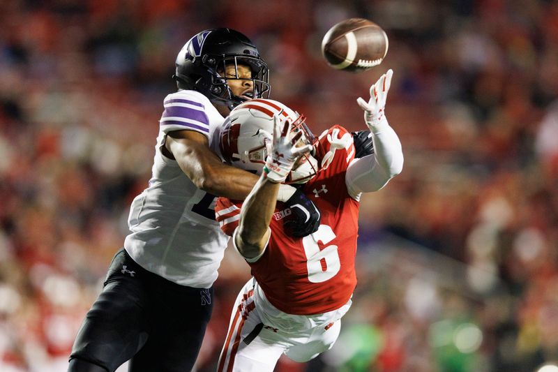 Nov 11, 2023; Madison, Wisconsin, USA;  Northwestern Wildcats defensive back Rod Heard II (24) defends the pass intended for Wisconsin Badgers wide receiver Will Pauling (6) during the fourth quarter at Camp Randall Stadium. Mandatory Credit: Jeff Hanisch-USA TODAY Sports