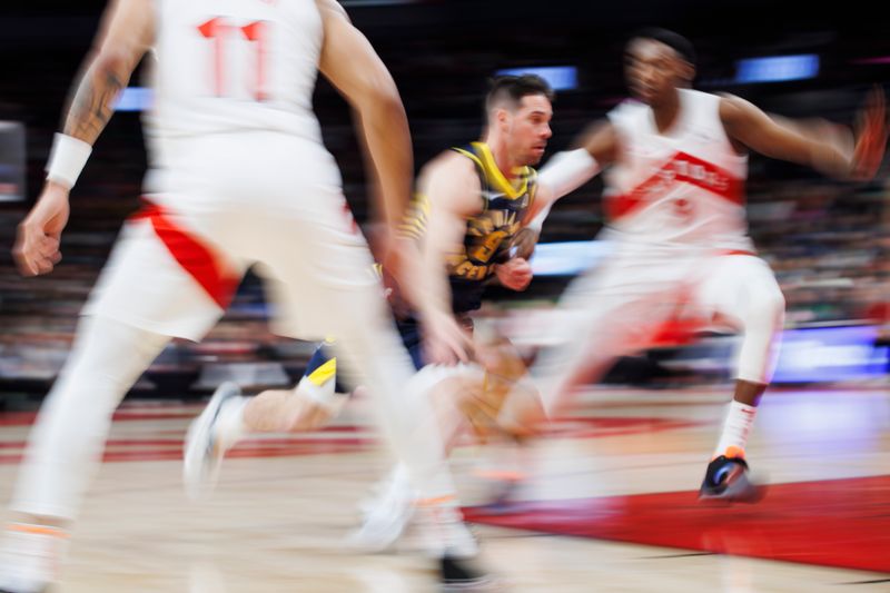 TORONTO, CANADA - APRIL 9: T.J. McConnell #9 of the Indiana Pacers drives to the net against the Toronto Raptors during second half of their NBA game at Scotiabank Arena on April 9, 2024 in Toronto, Canada. NOTE TO USER: User expressly acknowledges and agrees that, by downloading and or using this photograph, User is consenting to the terms and conditions of the Getty Images License Agreement. (Photo by Cole Burston/Getty Images)