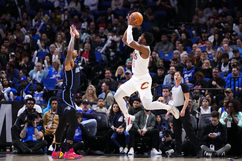 ORLANDO, FLORIDA - JANUARY 22: Donovan Mitchell #45 of the Cleveland Cavaliers goes up for a shot over Chuma Okeke #3 of the Orlando Magic during the third quarter at Kia Center on January 22, 2024 in Orlando, Florida. NOTE TO USER: User expressly acknowledges and agrees that, by downloading and or using this photograph, User is consenting to the terms and conditions of the Getty Images License Agreement. (Photo by Rich Storry/Getty Images)