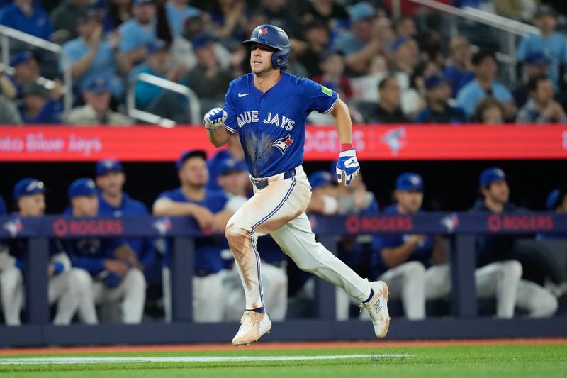 Apr 14, 2024; Toronto, Ontario, CAN; Toronto Blue Jays third baseman Ernie Clement (28) scores on a single hit by  second baseman Isiah Kiner-Falefa (not pictured) during the eighth inning against the Colorado Rockies at Rogers Centre. Mandatory Credit: John E. Sokolowski-USA TODAY Sports
