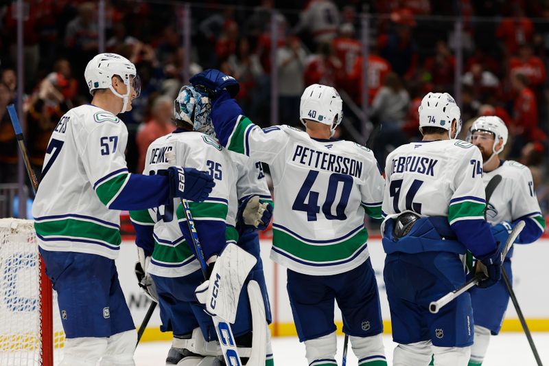 Oct 19, 2025; Washington, District of Columbia, USA; Vancouver Canucks goaltender Thatcher Demko (35) celebrates with teammates after their game against the Washington Capitals at Capital One Arena. Mandatory Credit: Geoff Burke-Imagn Images
