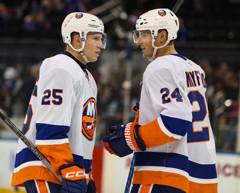 Sep 24, 2024; New York, New York, USA; New York Islanders defenseman Scott Mayfield (24) speaks with defenseman Dennis Cholowski (25) during the third period against the New York Rangers at Madison Square Garden. Mandatory Credit: Danny Wild-Imagn Images