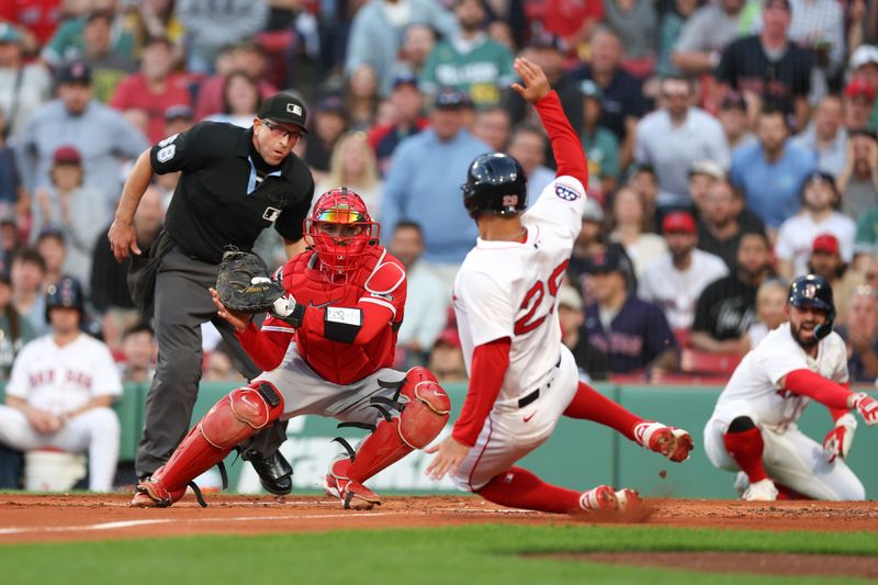 Jun 3, 2025; Boston, Massachusetts, USA; Los Angeles Angels catcher Travis d'Arnaud (25) tags out Boston Red Sox third baseman Abraham Toro (29) during the second inning at Fenway Park. Mandatory Credit: Paul Rutherford-Imagn Images