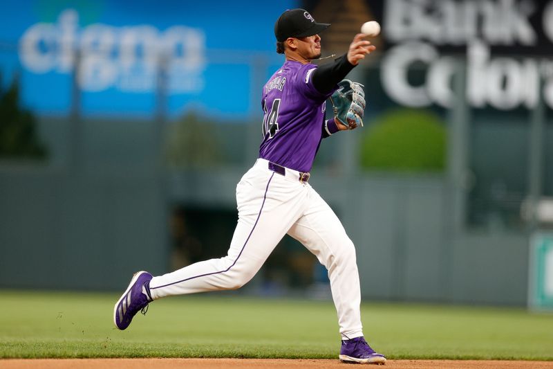 Apr 22, 2024; Denver, Colorado, USA; Colorado Rockies shortstop Ezequiel Tovar (14) makes a throw to first for an out in the fifth inning against the San Diego Padres at Coors Field. Mandatory Credit: Isaiah J. Downing-USA TODAY Sports