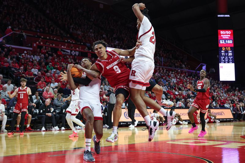 Jan 6, 2025; Piscataway, New Jersey, USA; Rutgers Scarlet Knights guard Ace Bailey (4) battle for a rebound against Wisconsin Badgers guard John Tonje (9) during the first half at Jersey Mike's Arena. Mandatory Credit: Vincent Carchietta-Imagn Images