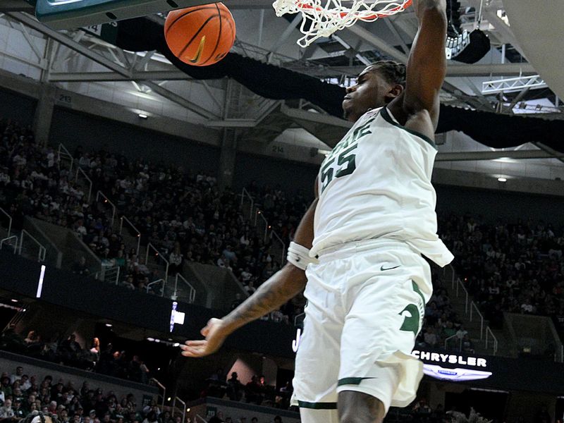 Mar 5, 2026; East Lansing, Michigan, USA;  Michigan State Spartans forward Coen Carr (55) dunks the ball against the Rutgers Scarlet Knights at Jack Breslin Student Events Center. Mandatory Credit: Dale Young-Imagn Images