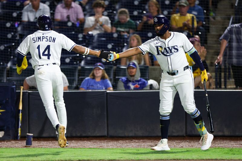 Sep 17, 2025; Tampa, Florida, USA; Tampa Bay Rays third baseman Junior Caminero (13) greets center fielder Chandler Simpson (14) after scoring a run against the Toronto Blue Jays in the first inning  at George M. Steinbrenner Field. Mandatory Credit: Nathan Ray Seebeck-Imagn Images