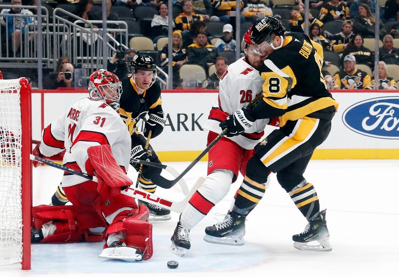 Oct 18, 2024; Pittsburgh, Pennsylvania, USA;  Carolina Hurricanes goaltender Frederik Andersen (31) makes a save against Pittsburgh Penguins left wing Michael Bunting (8) as Hurricanes defenseman Sean Walker defends during the third period at PPG Paints Arena. Mandatory Credit: Charles LeClaire-Imagn Images