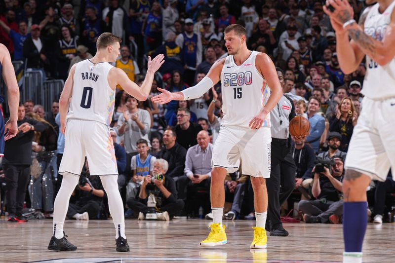 DENVER, CO - APRIL 29: Christian Braun #0 high fives Nikola Jokic #15 of the Denver Nuggets during the game against the LA Clippers on April 29, 2025 at Ball Arena in Denver, Colorado. NOTE TO USER: User expressly acknowledges and agrees that, by downloading and/or using this Photograph, user is consenting to the terms and conditions of the Getty Images License Agreement. Mandatory Copyright Notice: Copyright 2025 NBAE (Photo by Garrett Ellwood/NBAE via Getty Images)