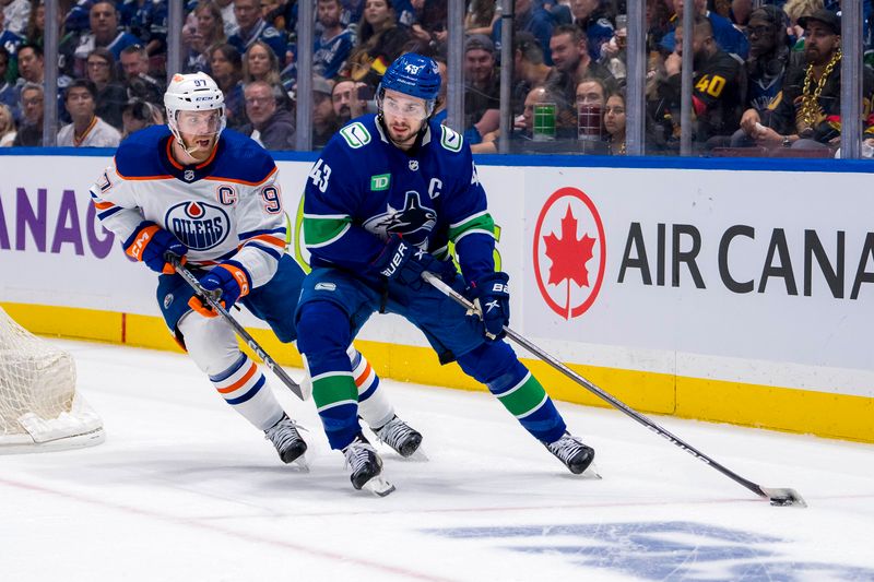 May 16, 2024; Vancouver, British Columbia, CAN; Edmonton Oilers forward Connor McDavid (97) defends against Vancouver Canucks defenseman Quinn Hughes (43) during the first period in game five of the second round of the 2024 Stanley Cup Playoffs at Rogers Arena. Mandatory Credit: Bob Frid-USA TODAY Sports