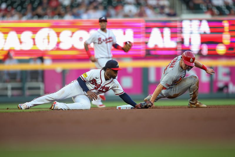 Sep 7, 2023; Atlanta, Georgia, USA; Atlanta Braves second baseman Ozzie Albies (1) tags out St. Louis Cardinals center fielder Tommy Edman (19) on a steal attempt in the first inning at Truist Park. Mandatory Credit: Brett Davis-USA TODAY Sports
