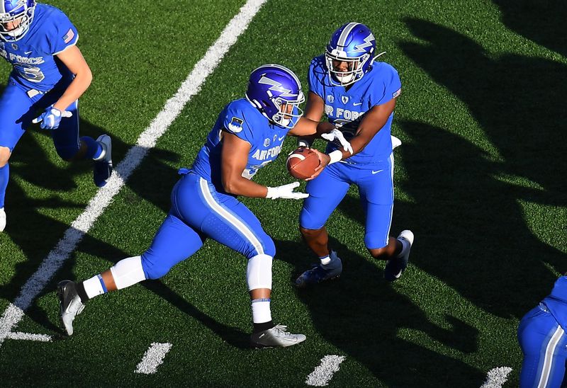 Oct 31, 2020; Colorado Springs, Colorado, USA; Air Force Falcons quarterback Warren Bryan (6) hands the ball off to fullback Matthew Murla (32) against the Boise State Broncos in the first quarter at Falcon Stadium. Mandatory Credit: Ron Chenoy-USA TODAY Sports